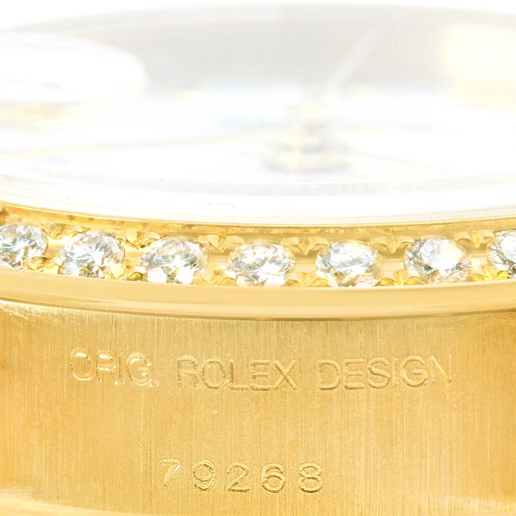 The image shows a close-up of the bezel with diamonds and the engraved case of a Rolex President 79268 Women's Yellow Gold White Dial 79268 Women's Yellow Gold White Dial model 79268.