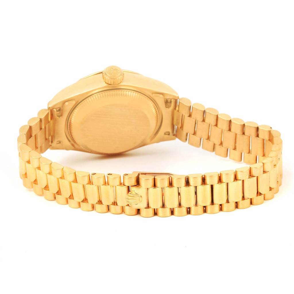 The image shows the back view of a Rolex President 79268 Women's Yellow Gold White Dial 79268 Women's Yellow Gold White Dial model watch, highlighting its gold bracelet and clasp.