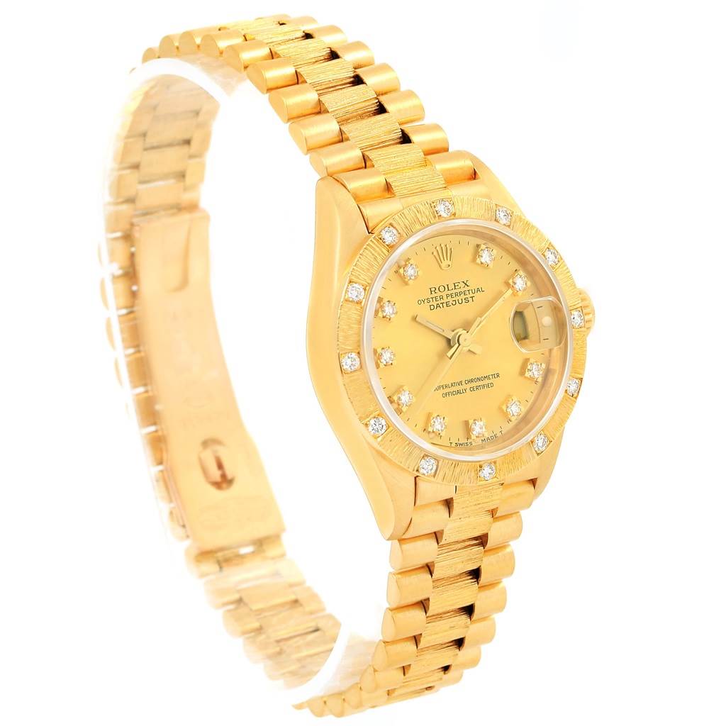 The image shows a Rolex President 69288 Women's Yellow Gold Champagne Dial 69288 Women's Yellow Gold Champagne Dial model watch at a three-quarter angle, highlighting its gold bracelet, dial, and bezel set with diamonds.