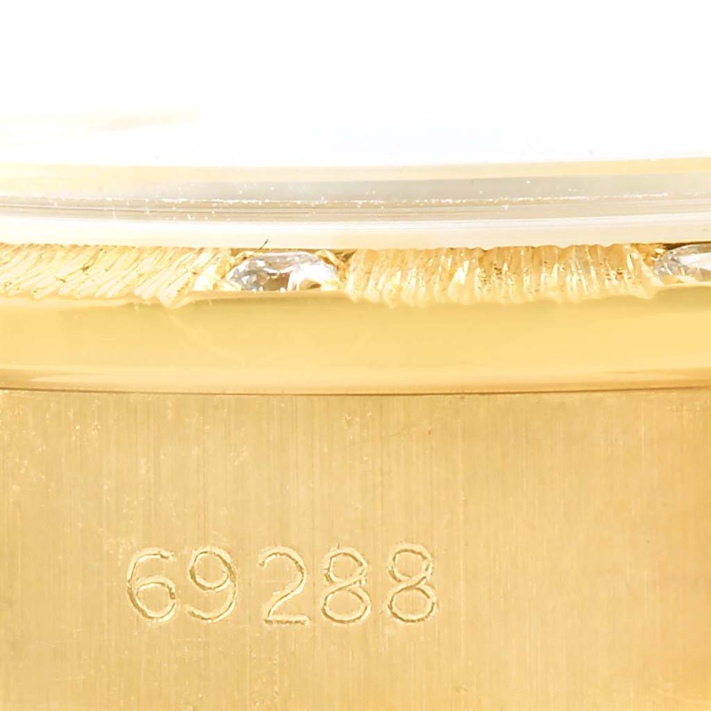 The image shows a close-up angle of the gold case and partially the bezel of a Rolex President 69288 Women's Yellow Gold Champagne Dial 69288 Women's Yellow Gold Champagne Dial model watch with the numbers "69288" engraved.