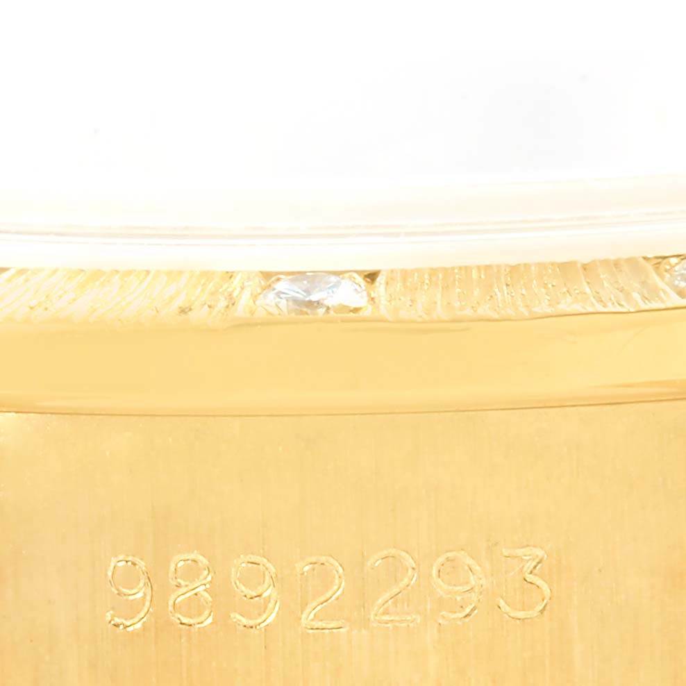 This close-up shows the serial number on the gold case side of a Rolex President 69288 Women's Yellow Gold Champagne Dial 69288 Women's Yellow Gold Champagne Dial watch, emphasizing the detailed craftsmanship.