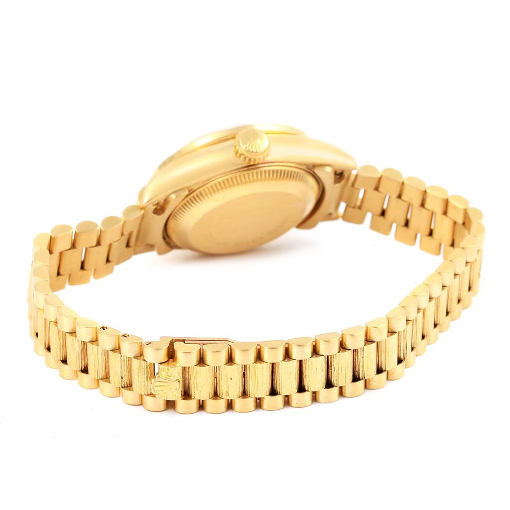 The image shows the back of a Rolex President 69288 Women's Yellow Gold Champagne Dial 69288 Women's Yellow Gold Champagne Dial model, focusing on its case back, crown, and bracelet.