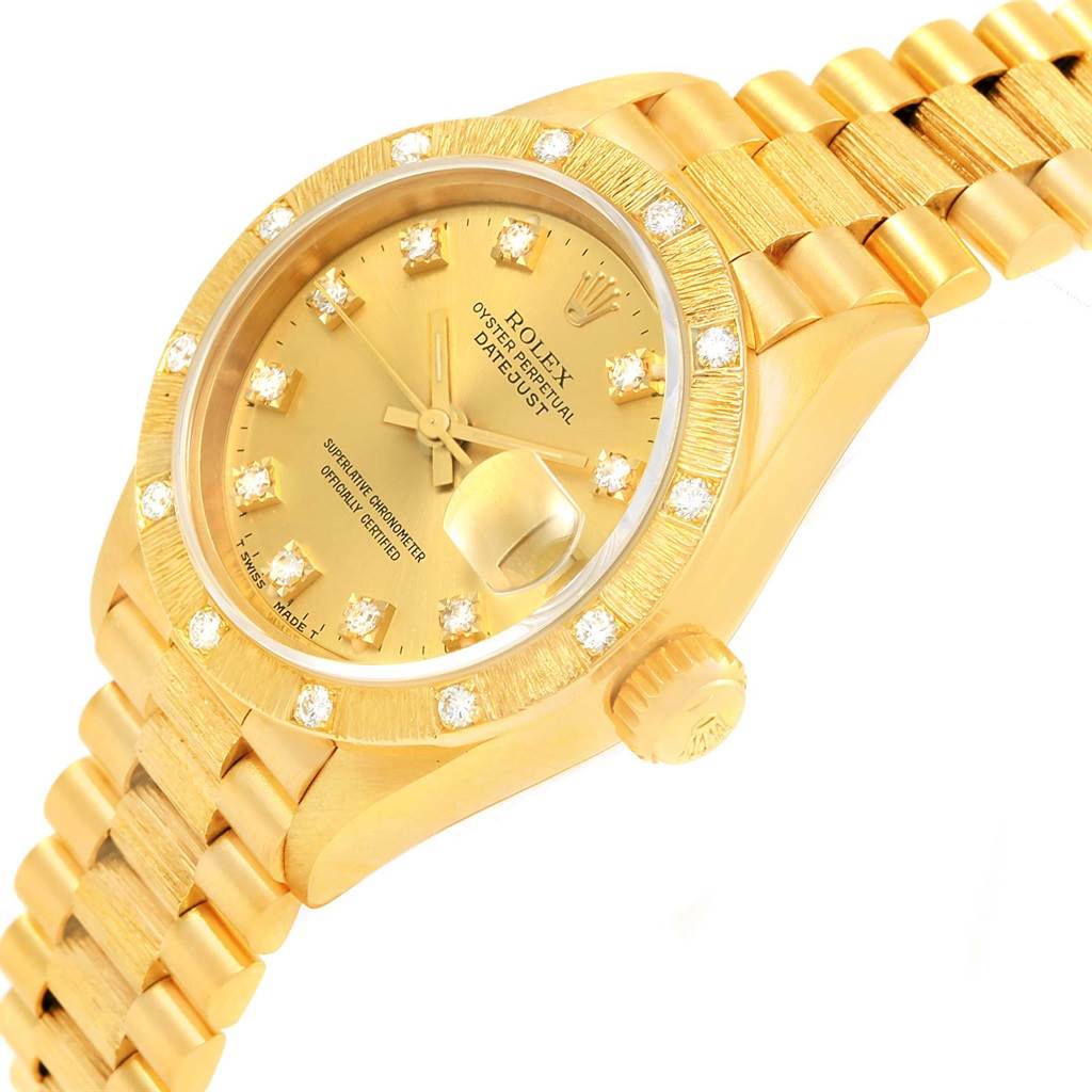 This image shows a Rolex President 69288 Women's Yellow Gold Champagne Dial 69288 Women's Yellow Gold Champagne Dial model watch at an angled view, displaying its gold casing, bracelet, and diamond-studded bezel.