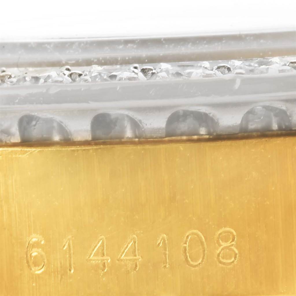 This close-up image shows the serial number on the gold bezel of the Rolex President 6917 Women's Yellow Gold Champagne Dial 6917 Women's Yellow Gold Champagne Dial model watch.