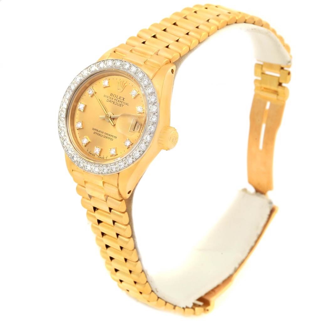 The image shows a Rolex President 6917 Women's Yellow Gold Champagne Dial 6917 Women's Yellow Gold Champagne Dial model watch at an angle displaying the bracelet, bezel, crown, and partially opened clasp.