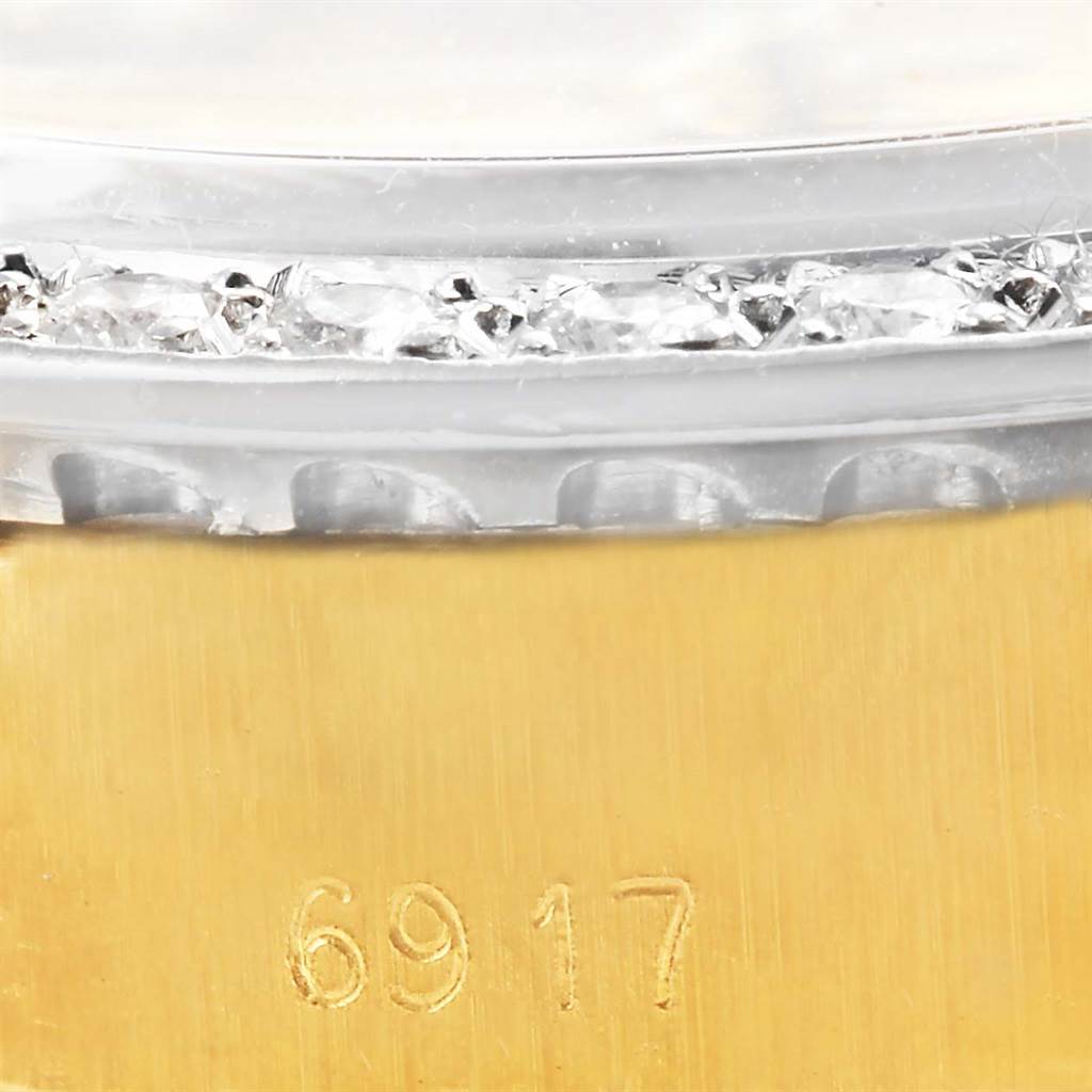 Close-up of the Rolex President 6917 Women's Yellow Gold Champagne Dial 6917 Women's Yellow Gold Champagne Dial model showing the bezel with diamonds and part of the serial number.