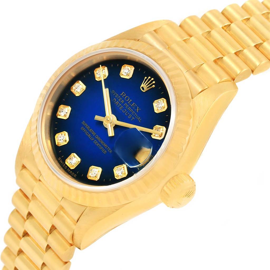 This image shows a Rolex President 69178 Women's Yellow Gold Blue Dial 69178 Women's Yellow Gold Blue Dial model watch from an angled view, highlighting the gold case, blue dial with diamond markers, and the crown.