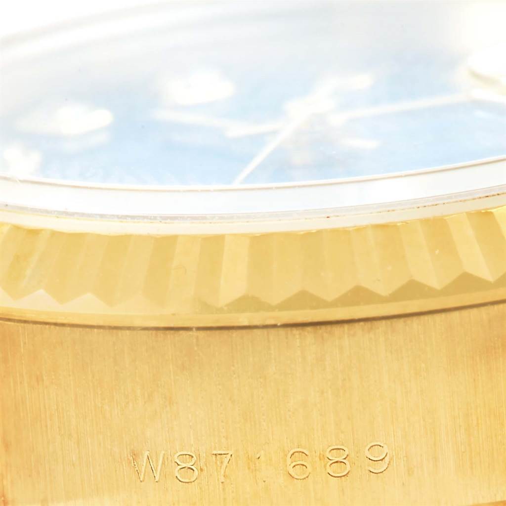This image shows a close-up of the serial number and the fluted bezel of a Rolex President 69178 Women's Yellow Gold Blue Dial 69178 Women's Yellow Gold Blue Dial model watch.