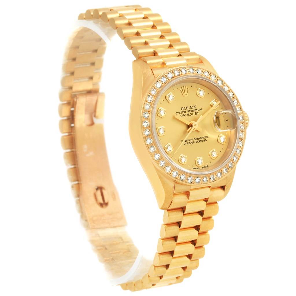 The image shows a Rolex President 69178 Women's Yellow Gold Champagne Dial 69178 Women's Yellow Gold Champagne Dial watch at an angle highlighting the gold bracelet, diamond bezel, and dial.