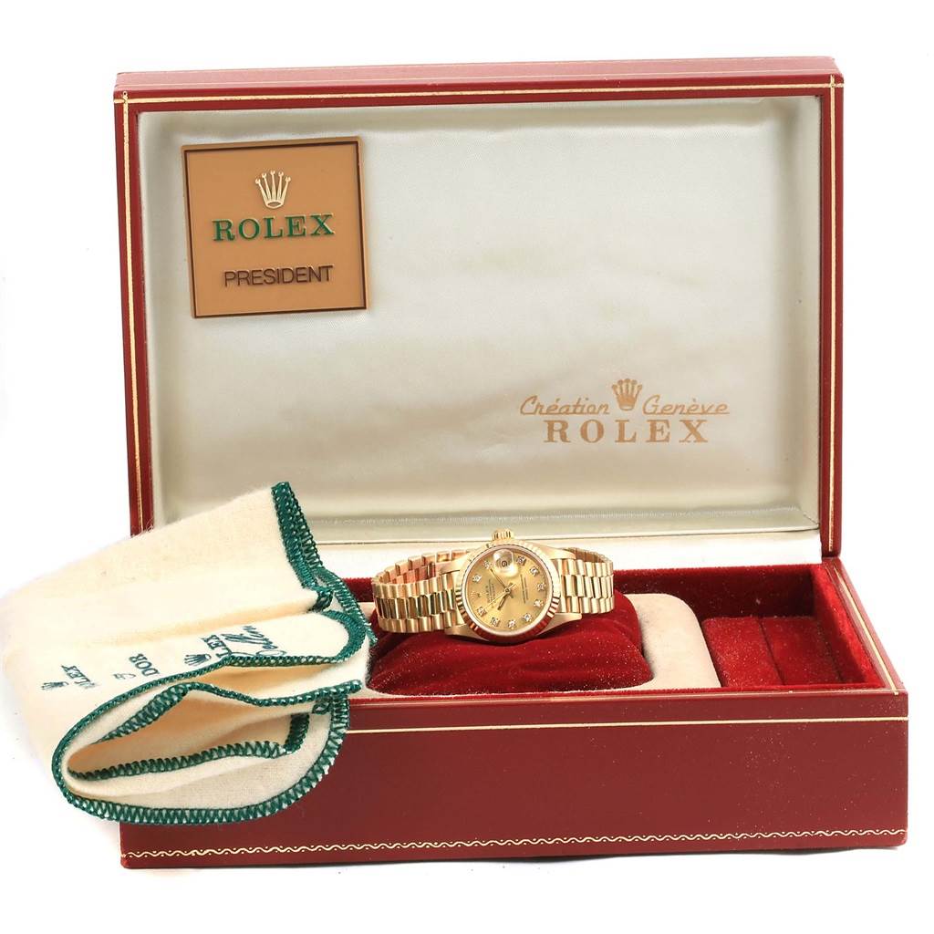 The image shows a Rolex President 69178 Women's Yellow Gold Champagne Dial 69178 Women's Yellow Gold Champagne Dial watch from a front angle, displayed in its open box with a cleaning cloth beside it.