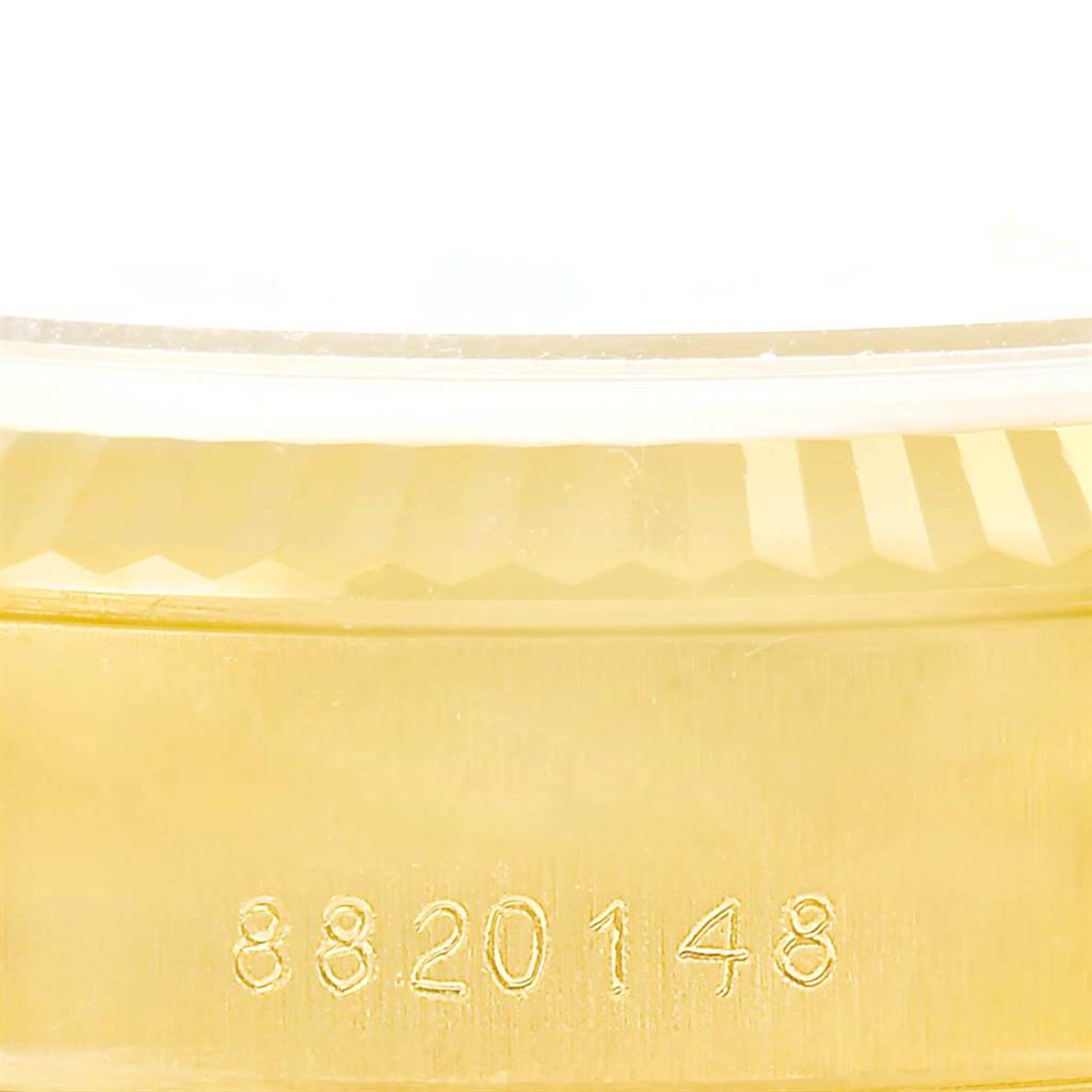 This image shows the serial number and part of the bezel of a Rolex President 69178 Women's Yellow Gold Champagne Dial 69178 Women's Yellow Gold Champagne Dial model watch.