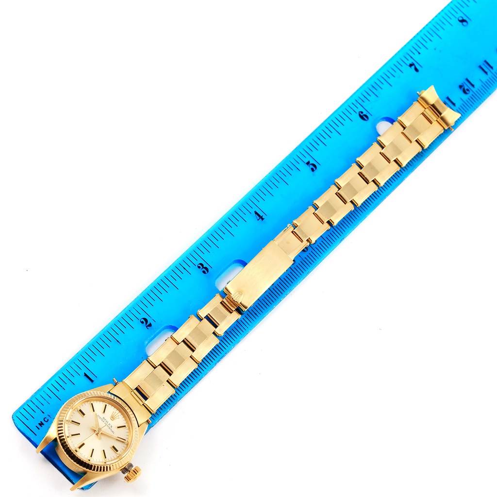 The image shows a gold Rolex President 6719 Women's Yellow Gold Silver Dial 6719 Women's Yellow Gold Silver Dial watch with a ruler for size reference, displaying the full band and face from a top-down angle.