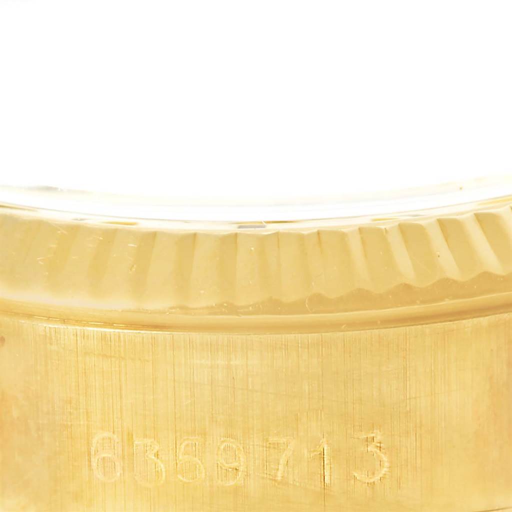 This image shows the engraved serial number on the side of the case of a Rolex President 6719 Women's Yellow Gold Silver Dial 6719 Women's Yellow Gold Silver Dial model watch.