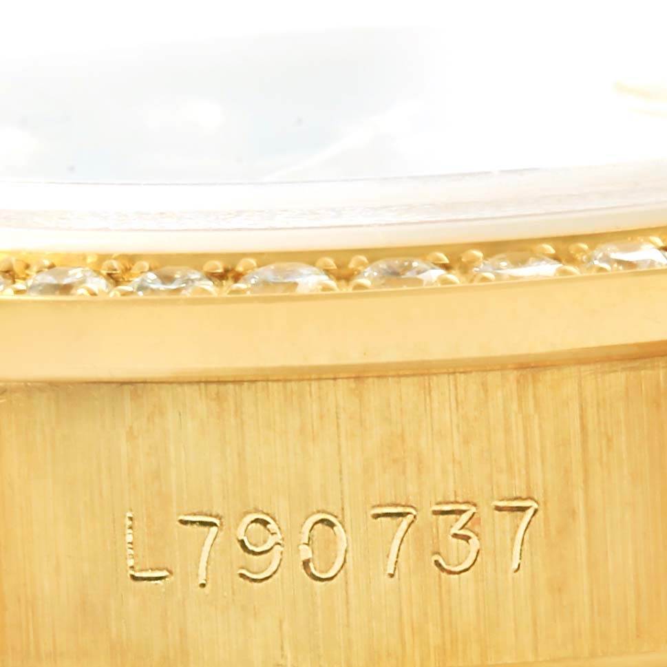 The image shows a close-up of the serial number and diamond bezel of a Rolex President 69138 Women's Yellow Gold Black Dial 69138 Women's Yellow Gold Black Dial model.
