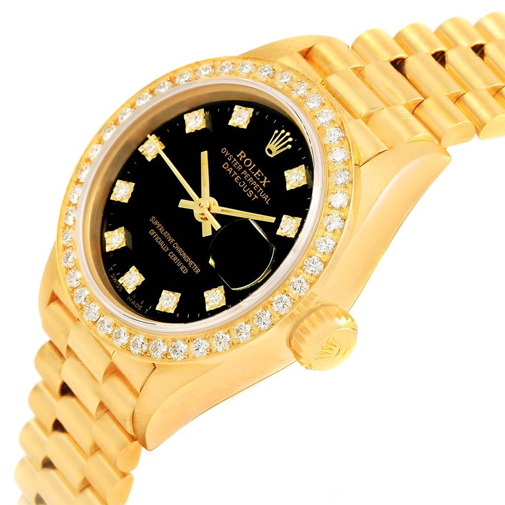 The Rolex President 69138 Women's Yellow Gold Black Dial 69138 Women's Yellow Gold Black Dial model watch is shown at a slight angle, highlighting the diamond bezel, black dial, and gold bracelet.