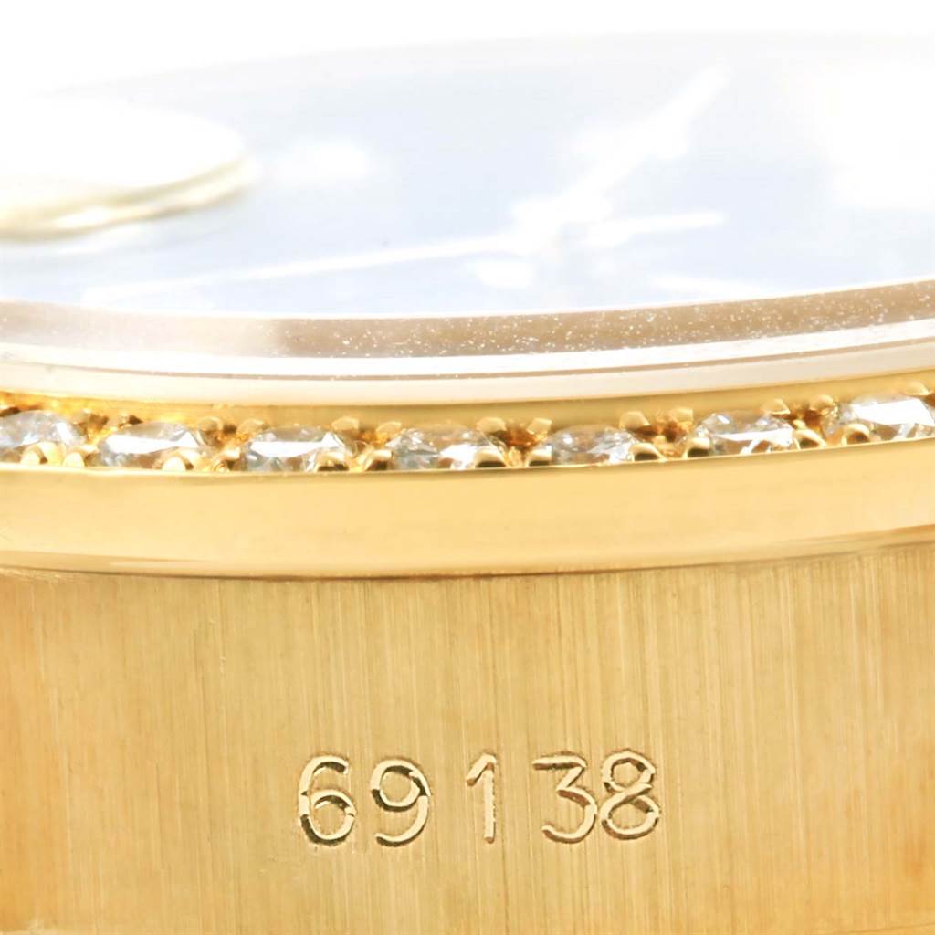 This close-up image of a Rolex President 69138 Women's Yellow Gold Black Dial 69138 Women's Yellow Gold Black Dial model watch shows the side view of the case with diamond accents and the model number 69138.
