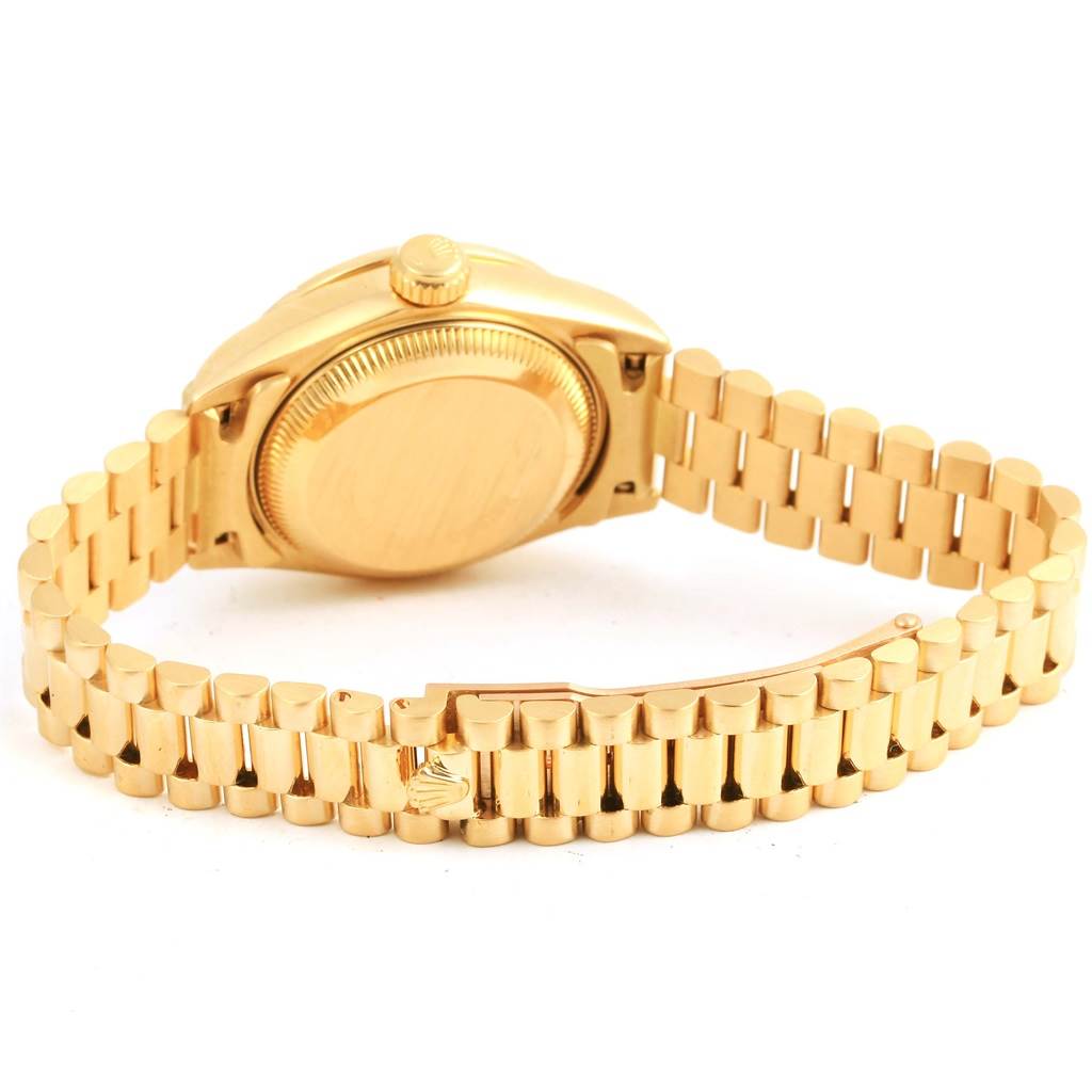 The image shows the back and bracelet of a Rolex President 69178 Women's Yellow Gold Champagne Dial 69178 Women's Yellow Gold Champagne Dial model watch at an angle.