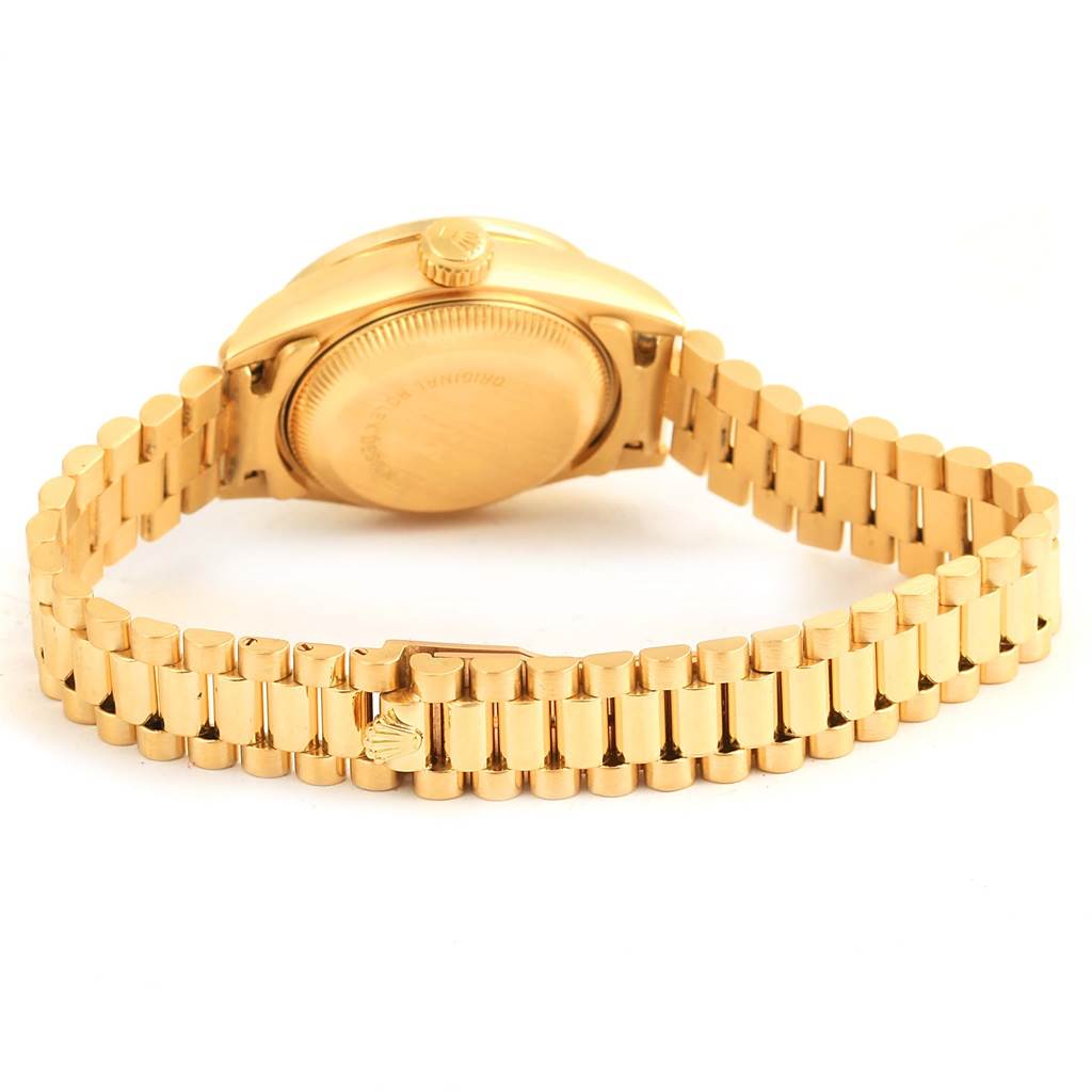 The image shows the back and side of the Rolex President 69198 Women's Yellow Gold Champagne Dial 69198 Women's Yellow Gold Champagne Dial model, highlighting the clasp and bracelet in a gold color.