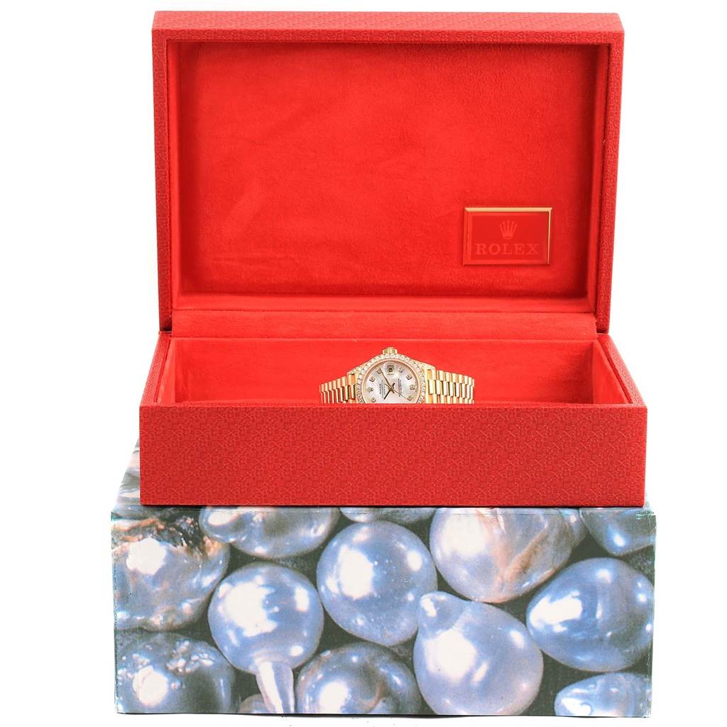 The Rolex President 79158 Women's Yellow Gold Mother of Pearl Dial 79158 Women's Yellow Gold Mother of Pearl Dial watch is shown front-facing in an open red box with a textured pattern.