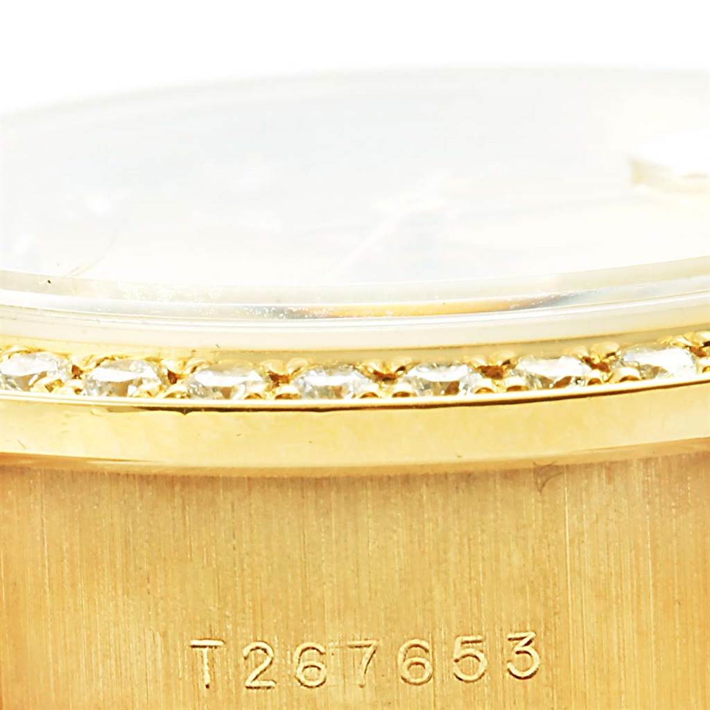 The image shows a close-up of the bezel and serial number on the case of a Rolex President 69138 Women's Yellow Gold Champagne Dial 69138 Women's Yellow Gold Champagne Dial model watch.