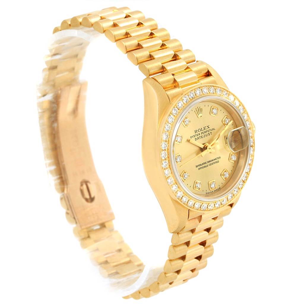 This image shows a side angle view of a Rolex President 69178 Women's Yellow Gold Champagne Dial 69178 Women's Yellow Gold Champagne Dial watch, displaying its bracelet, bezel encrusted with diamonds, and watch face.