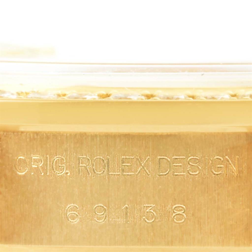 This image shows a close-up of the casing's edge with engravings on the Rolex President 69178 Women's Yellow Gold Champagne Dial 69178 Women's Yellow Gold Champagne Dial model watch.