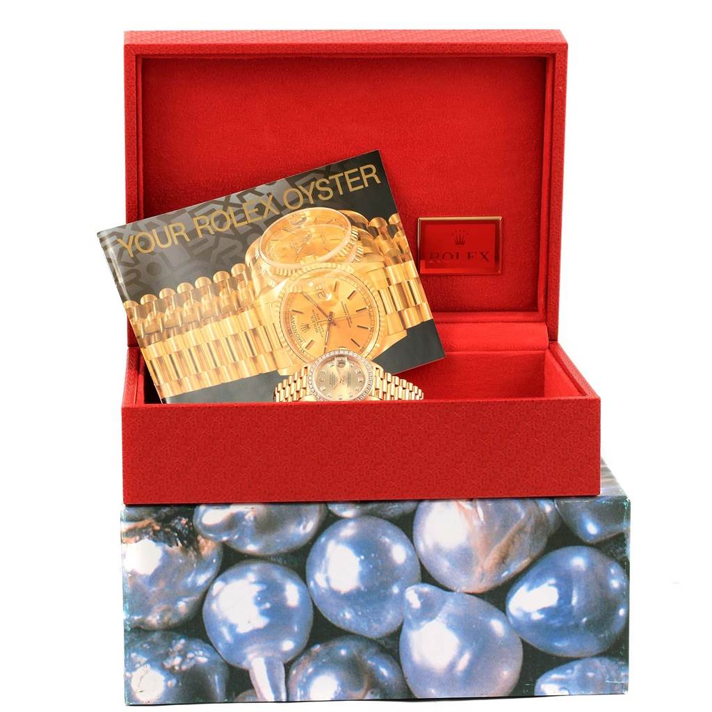 The image shows a Rolex President 69178 Women's Yellow Gold Champagne Dial 69178 Women's Yellow Gold Champagne Dial model watch inside an open Rolex box with a booklet displaying the watch.