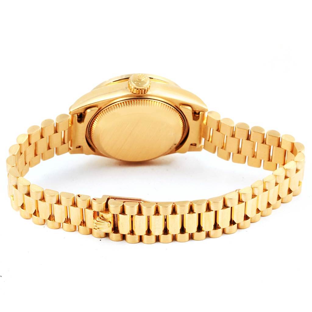 This Rolex President 69178 Women's Yellow Gold Champagne Dial 69178 Women's Yellow Gold Champagne Dial model watch is shown from the back, highlighting its clasp, bracelet, and case back.