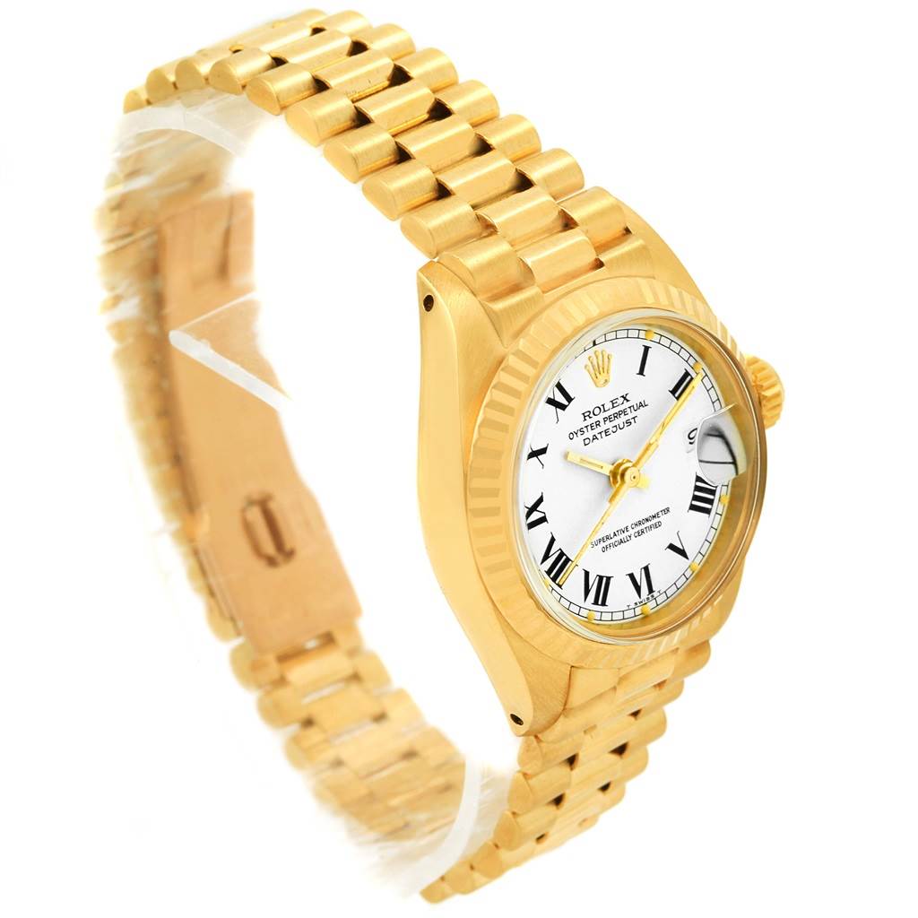 The image shows a side angle view of a Rolex President 6917 Women's Yellow Gold White Dial 6917 Women's Yellow Gold White Dial model watch, displaying its gold case, bracelet, and white dial.