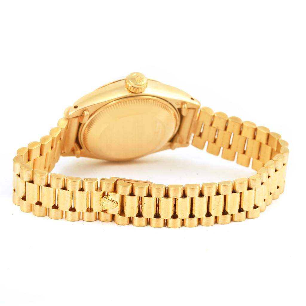 The image shows the back and bracelet of a Rolex President 6917 Women's Yellow Gold White Dial 6917 Women's Yellow Gold White Dial model watch from an angled rear view.