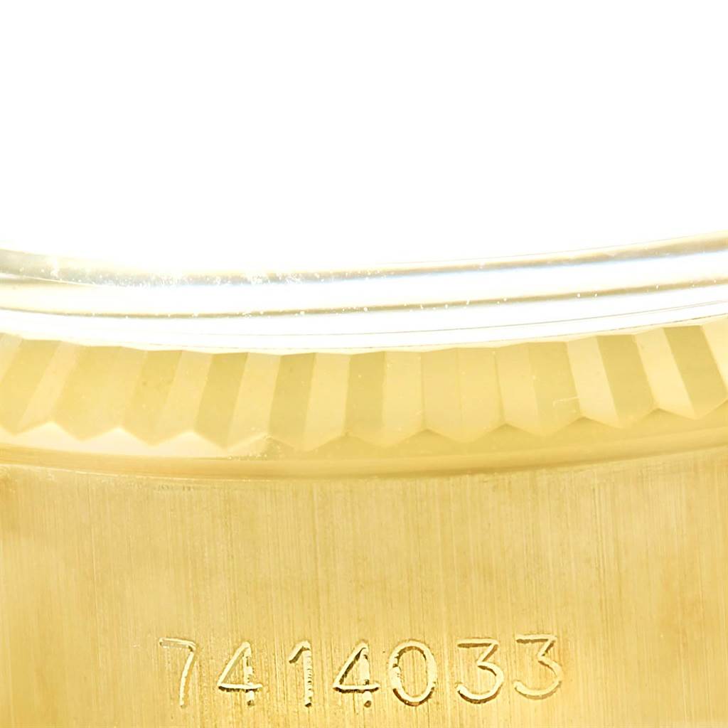 This close-up image shows the serial number and part of the fluted bezel of a Rolex President 6917 Women's Yellow Gold White Dial 6917 Women's Yellow Gold White Dial model watch.
