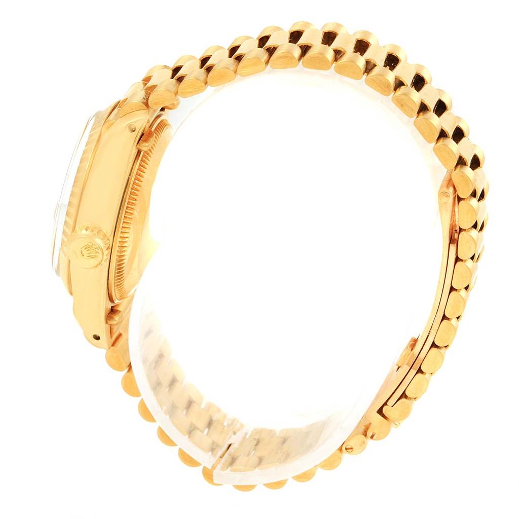 The image shows a side view of a Rolex President 6917 Women's Yellow Gold White Dial 6917 Women's Yellow Gold White Dial model watch, highlighting the gold bracelet and part of the case including the crown.