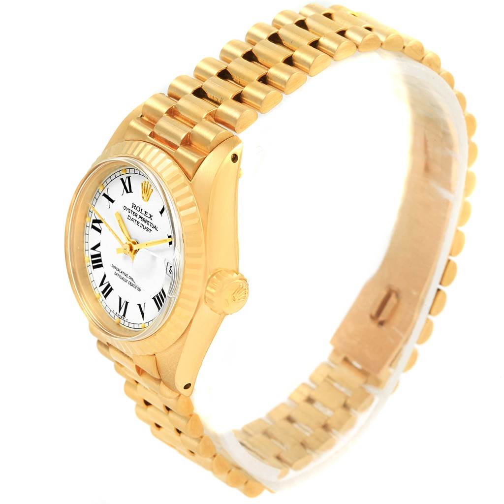 This image shows a Rolex President 6917 Women's Yellow Gold White Dial 6917 Women's Yellow Gold White Dial model watch from a side angle, highlighting the bracelet, case, and dial.