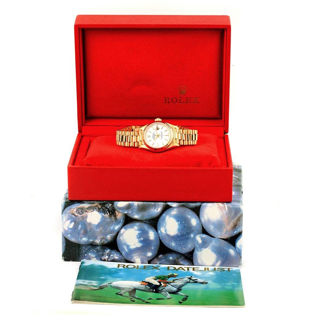 The Rolex President 69178 Women's Yellow Gold White Dial 69178 Women's Yellow Gold White Dial model watch is shown inside its open red box, with the manual placed in front.