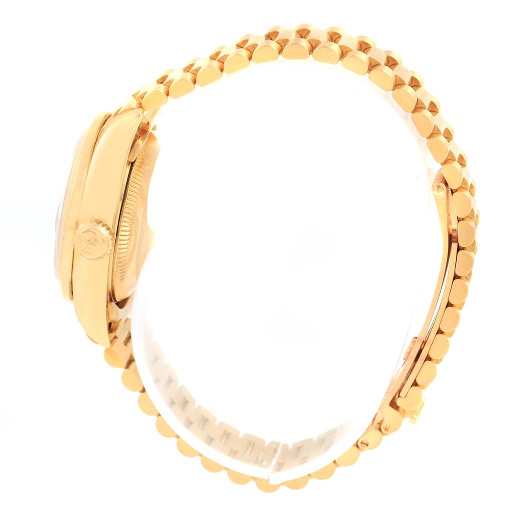 The image shows a side view of the Rolex President 69138 Women's Yellow Gold White Dial 69138 Women's Yellow Gold White Dial model watch, featuring its crown, case, and bracelet.