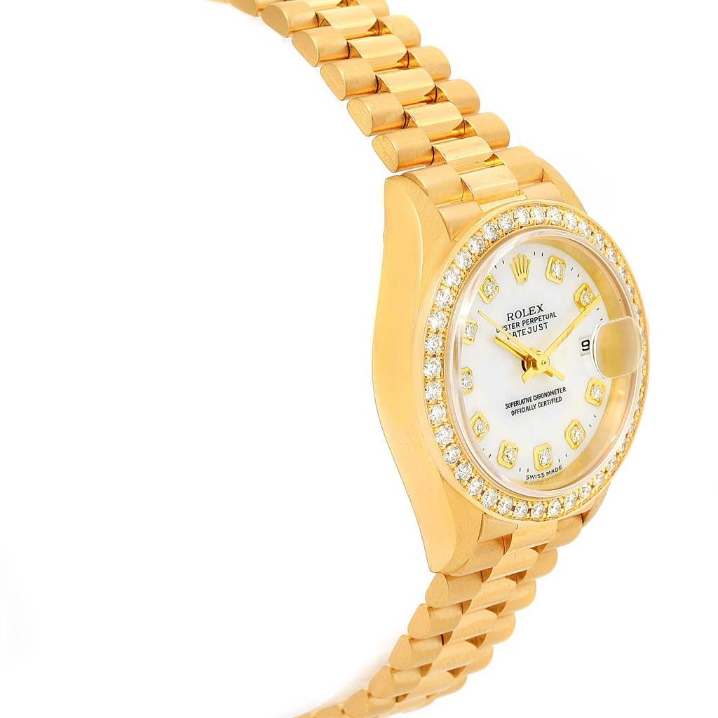 The image shows a side view of the Rolex President 69138 Women's Yellow Gold White Dial 69138 Women's Yellow Gold White Dial model watch, highlighting its gold bracelet, bezel, and diamond-encrusted dial.