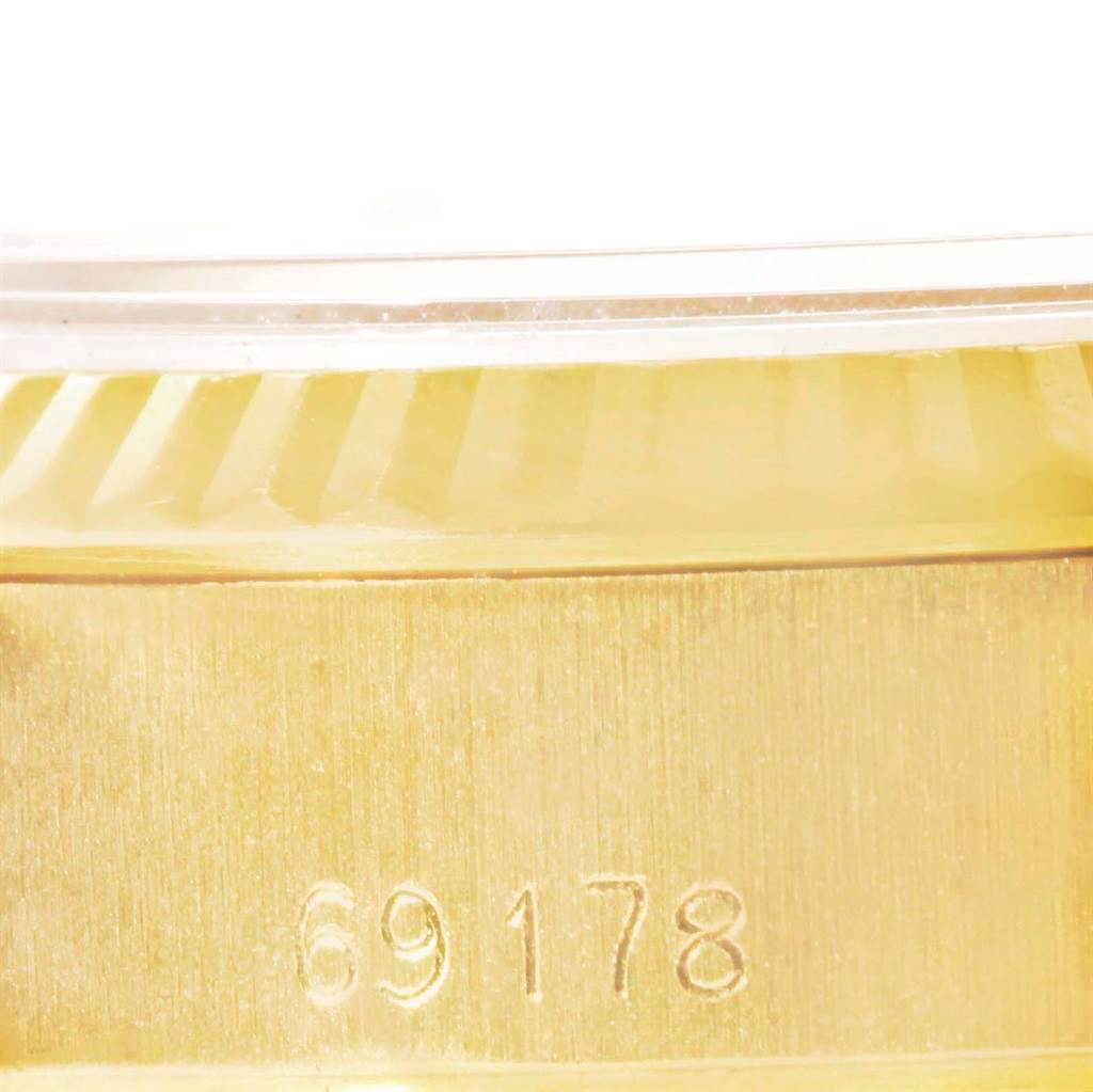 This image shows a close-up angle of the side of a Rolex President 69178 Women's Yellow Gold Champagne Dial 69178 Women's Yellow Gold Champagne Dial model watch, highlighting its serial number "69178" and fluted bezel.