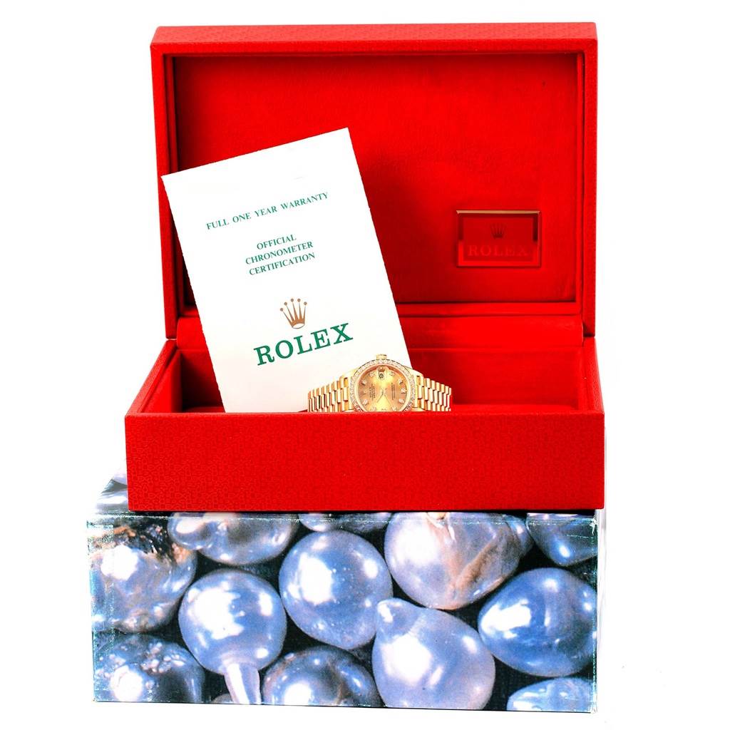 This image shows a Rolex President 69178 Women's Yellow Gold Champagne Dial 69178 Women's Yellow Gold Champagne Dial watch in a red box with certification documents.