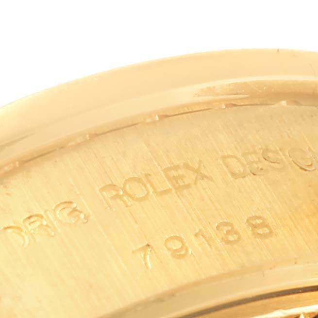 The image shows a close-up angle of the case back of a Rolex President 79138 Women's Yellow Gold Mother of Pearl Dial 79138 Women's Yellow Gold Mother of Pearl Dial model, displaying part of the engraved text and model number.