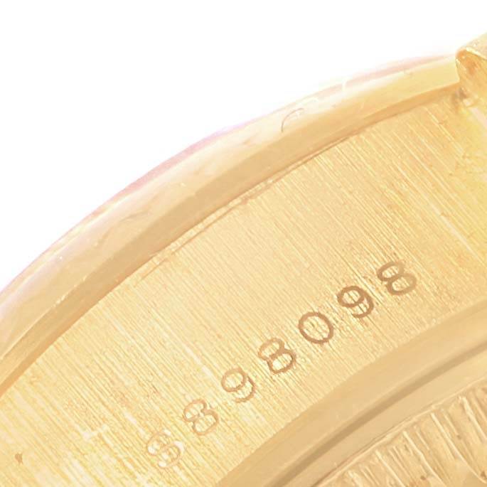 This close-up image shows the serial number engraved on the gold bezel of a Rolex President 69178 Women's Yellow Gold Blue Dial 69178 Women's Yellow Gold Blue Dial model watch.