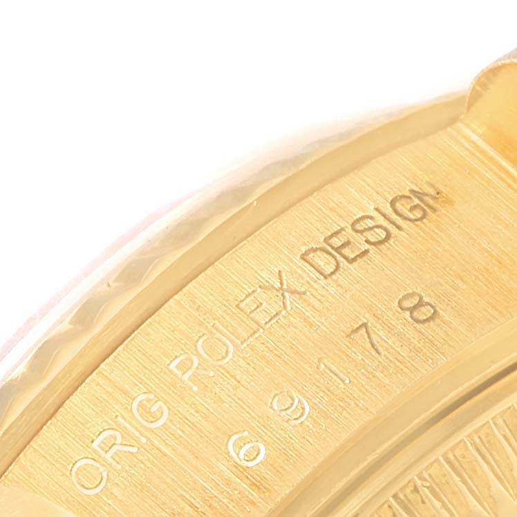 This close-up image shows the engraved inner case back of the Rolex President 69178 Women's Yellow Gold Blue Dial 69178 Women's Yellow Gold Blue Dial model, with "ORIG ROLEX DESIGN" and numbers visible.
