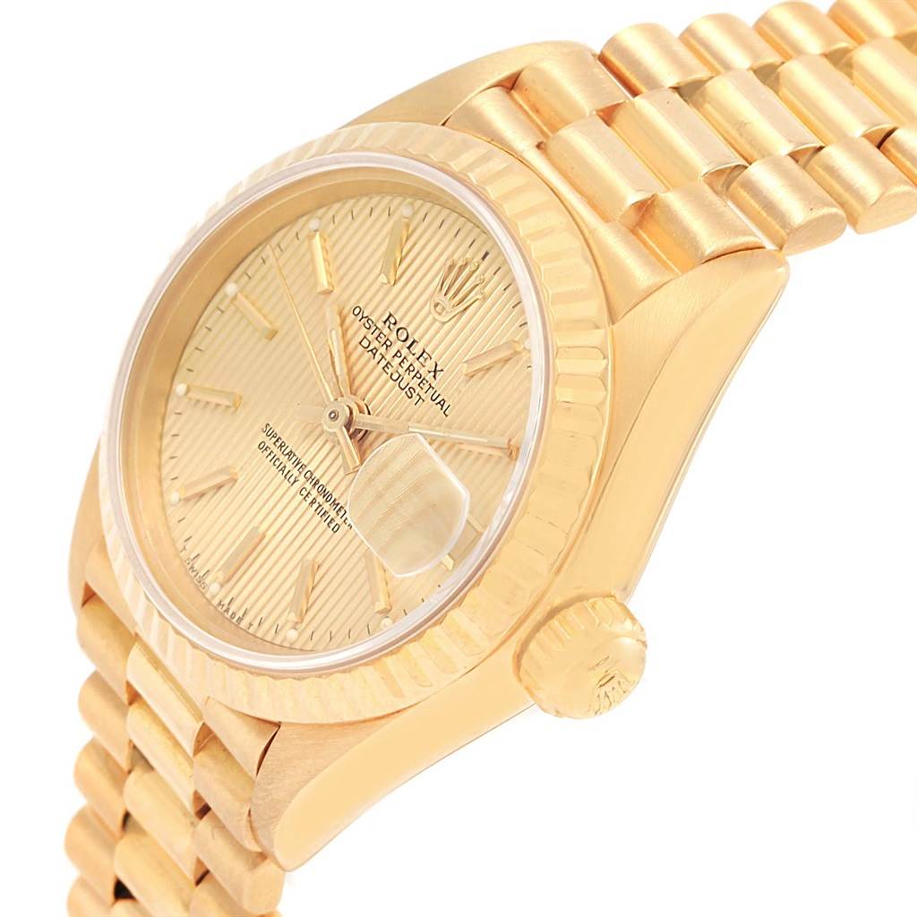 The image shows a side angle of a Rolex President 69178 Women's Yellow Gold Champagne Dial 69178 Women's Yellow Gold Champagne Dial model watch, featuring the face, bezel, and part of the bracelet.