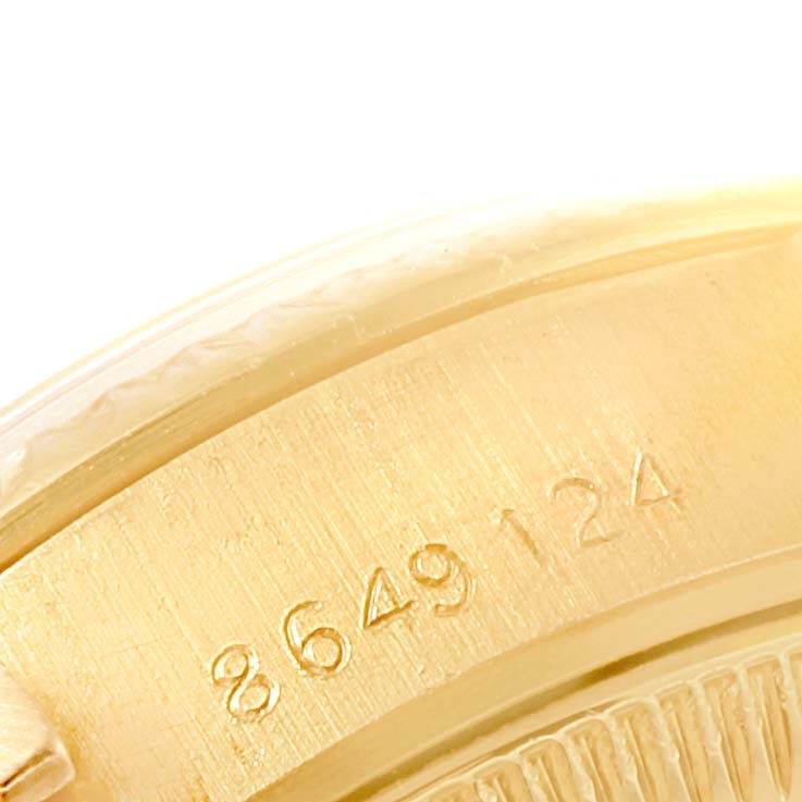 This image is a close-up of the side of a Rolex President 69178 Women's Yellow Gold Champagne Dial 69178 Women's Yellow Gold Champagne Dial model, showing part of the casing and the serial number.