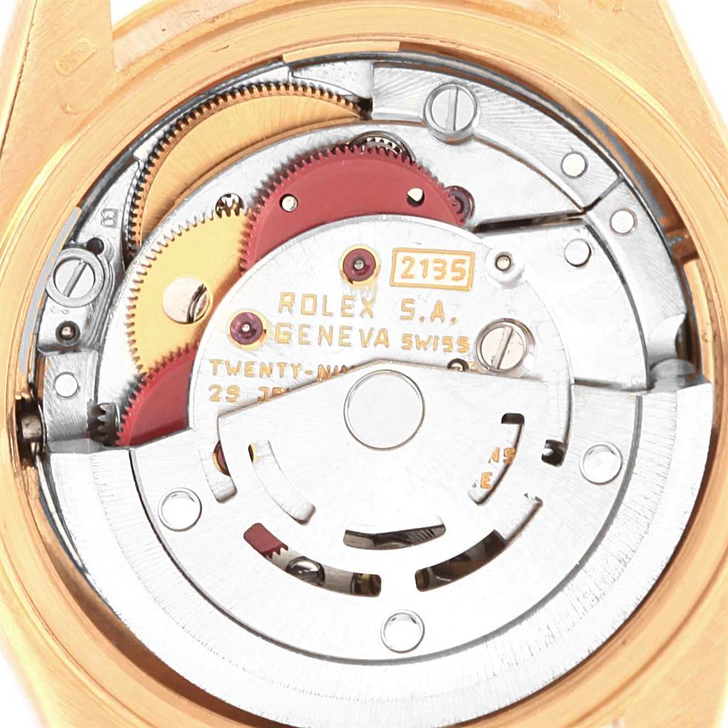 The image shows the internal mechanical movement of a Rolex President 69178 Women's Yellow Gold Champagne Dial 69178 Women's Yellow Gold Champagne Dial model, focusing on gears and engravings.