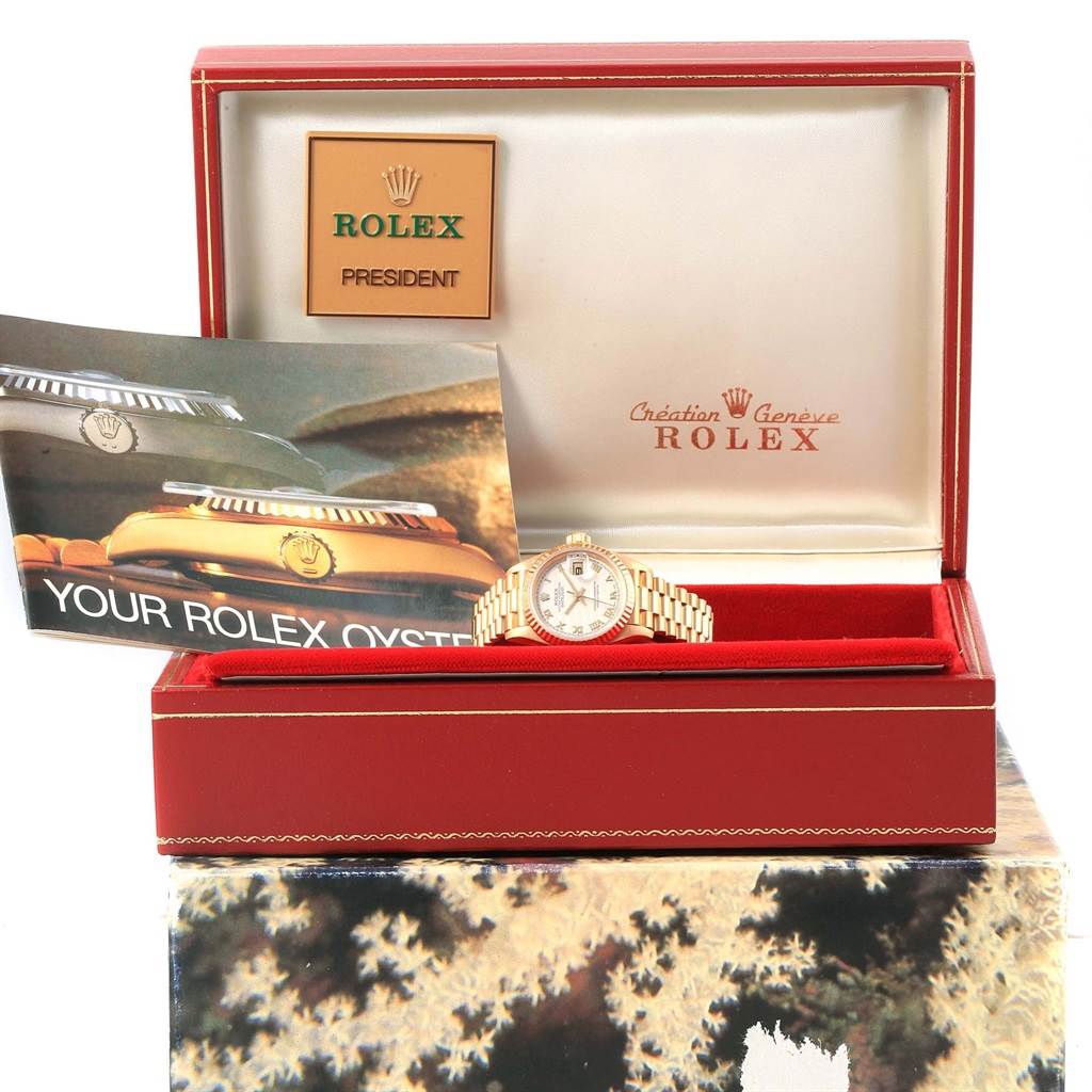 The Rolex President 79178 Women's Yellow Gold Beige Dial 79178 Women's Yellow Gold Beige Dial watch is shown in its open display box with accompanying literature and a plaque indicating the model name.