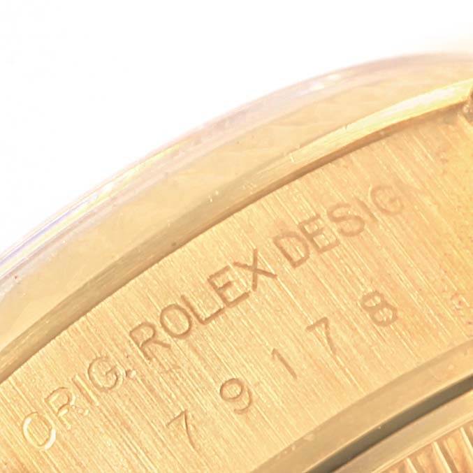 This close-up angle shows the engraved side of a Rolex President 79178 Women's Yellow Gold Beige Dial 79178 Women's Yellow Gold Beige Dial watch, with visible model details.