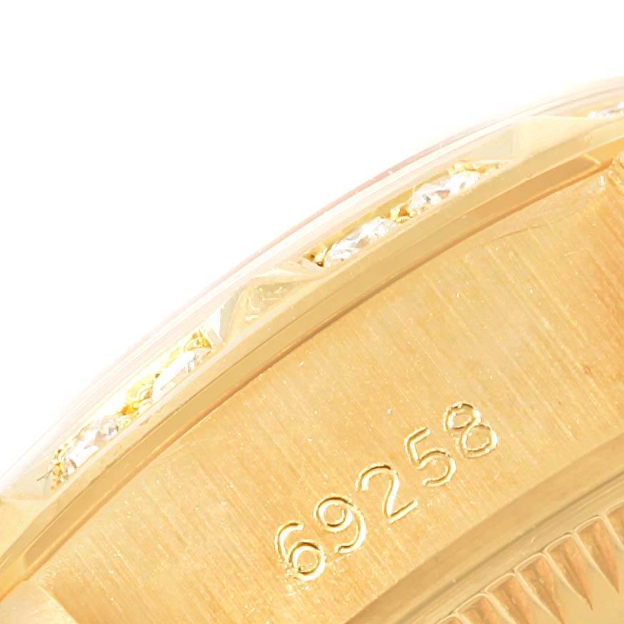 This image shows the side view of a Rolex President 69258 Women's Yellow Gold Champagne Dial 69258 Women's Yellow Gold Champagne Dial model watch, highlighting its serial number and bezel with embedded gems.