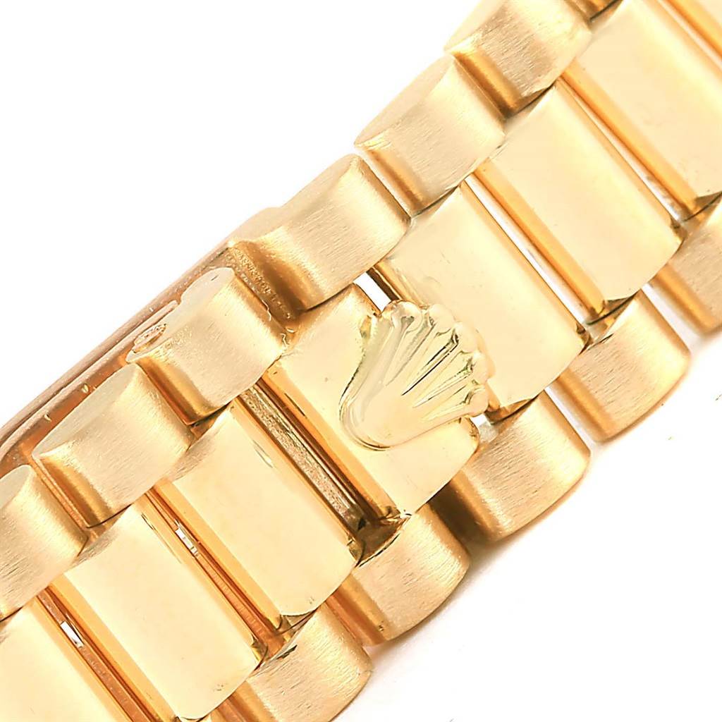 This image shows a close-up of a gold bracelet link of the Rolex President 69258 Women's Yellow Gold Champagne Dial 69258 Women's Yellow Gold Champagne Dial model watch, featuring the Rolex crown logo.