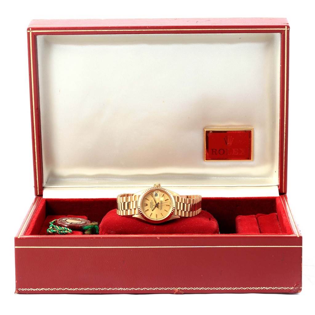 The Rolex President 6917 Women's Yellow Gold Champagne Dial 6917 Women's Yellow Gold Champagne Dial watch is displayed front and center within its open box, showing the dial and band.