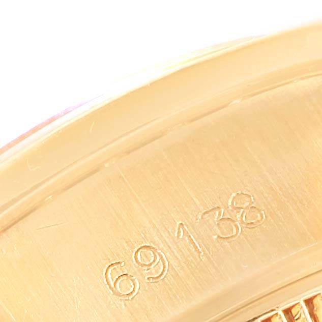 This close-up image shows the model number engraving on the case of a Rolex President 69138 Women's Yellow Gold Champagne Dial 69138 Women's Yellow Gold Champagne Dial watch.